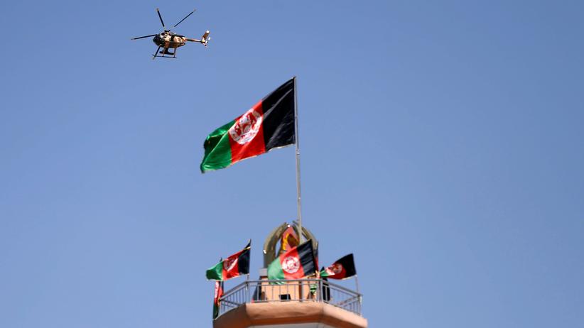   Afghanistan: A military helicopter is flying over Kabul. 