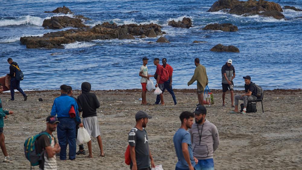 Spanische Exklave: Menschen, die aus Marokko nach Ceuta gekommen sind, harren am Strand aus.