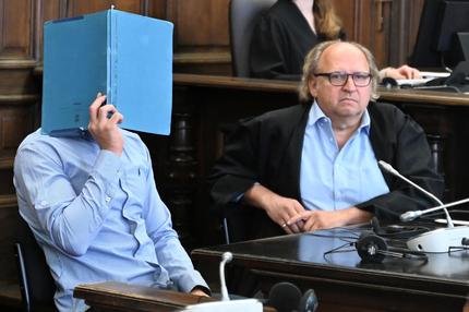 Prozess in Hamburg: Der Angeklagte sitzt mit seinem Anwalt Tim Burkert (r) im Strafjustizgebäude in Hamburg. Er soll mit seiner Ex-Freundin in deren Wohnung im 4. Obergeschoss in Hamburg-Eilbek in einen Streit geraten sein und gewaltsam auf sie eingewirkt haben. Die Frau soll daraufhin in Panik geraten und über das Geländer des zu ihrer Wohnung gehörenden Balkons gestiegen sein, von dort stürzte sie in die Tiefe und starb.