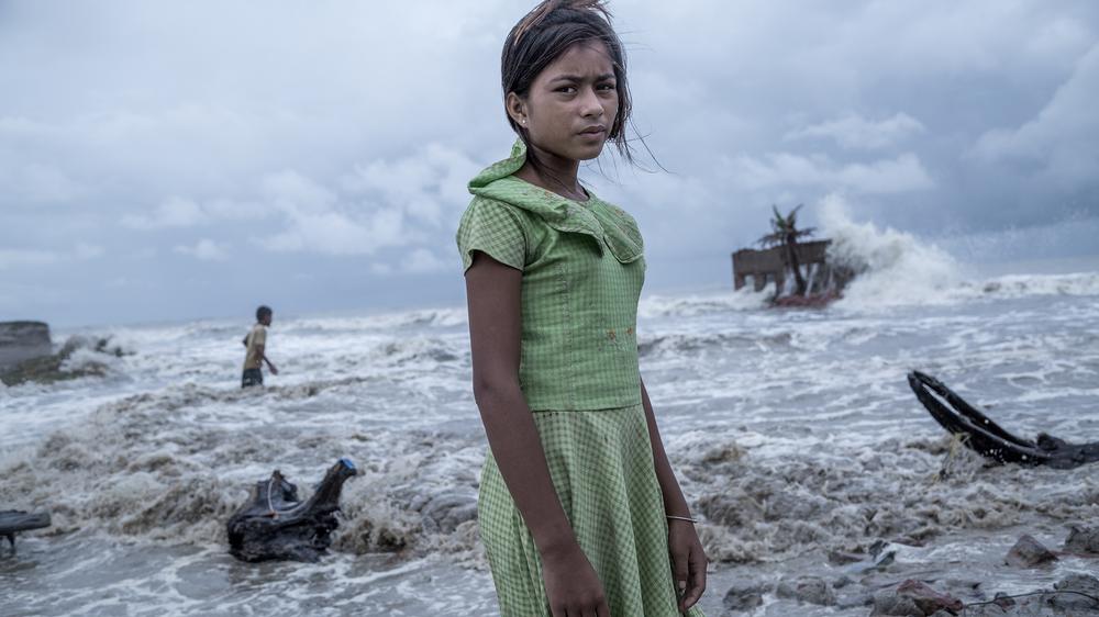 Klimawandel: Ein Mädchen steht vor ihrem Teeladen, der durch das Meerwasser auf der Insel Namkhana völlig zerstört ist. Die als Weltnaturerbe bekannte indisch-bangladeschische Region Sundarbans ist für ihre exquisiten Waldbestände bekannt, litt aber zuletzt unter Stürmen, Erosion und dem Anstieg des Meeresspiegels.
