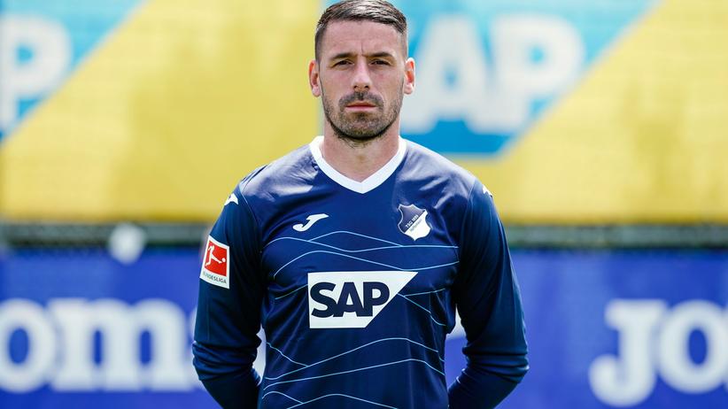 Regensburg's goalkeeper Philipp Pentke picks up a seat that was thrown onto  the turf during the German Bundesliga 2nd division relegation soccer match  between TSV 1860 Munich and Jahn Regensburg in the