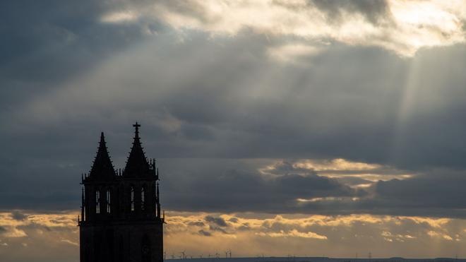 Wetter: Für einen kurzen Moment bricht die Sonne durch die Wolken, die über dem Dom und der Landeshauptstadt ziehen.