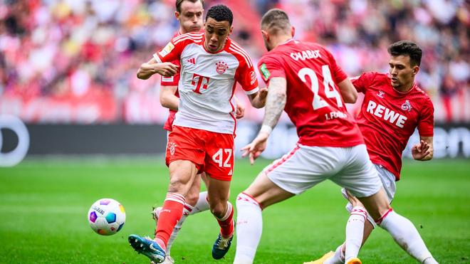 Bundesliga: Münchens Jamal Musiala (l) in Aktion gegen Kölns Julian Chabot (M) und Kölns Dejan Ljubicic (r).