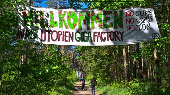 Auto: Aktivisten der Initiative „Stoppt Tesla“ hängten in einem Wald nahe der Tesla Gigafactory Berlin-Brandenburg ein Banner mit der Aufschrift „Willkommen in der Utopia Giga Factory, keine Bullen, keine Nazis, kein Elon“.