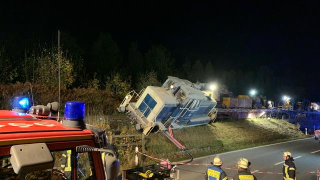 Bedrohliche Schräglage: Entgleiste Güterzuglok droht auf Straße zu stürzen