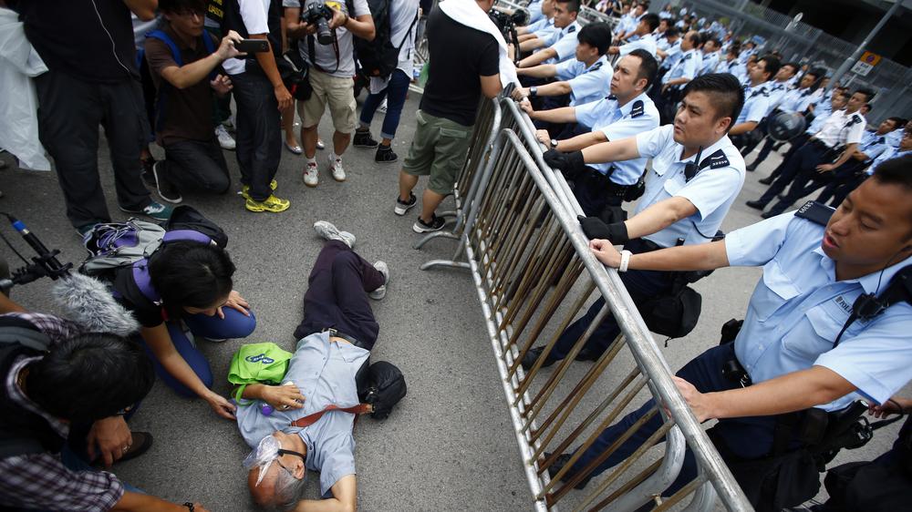 Hongkong: Polizisten und Demonstranten stehen einander vor Hongkongs  Regierungssitz gegenüber.