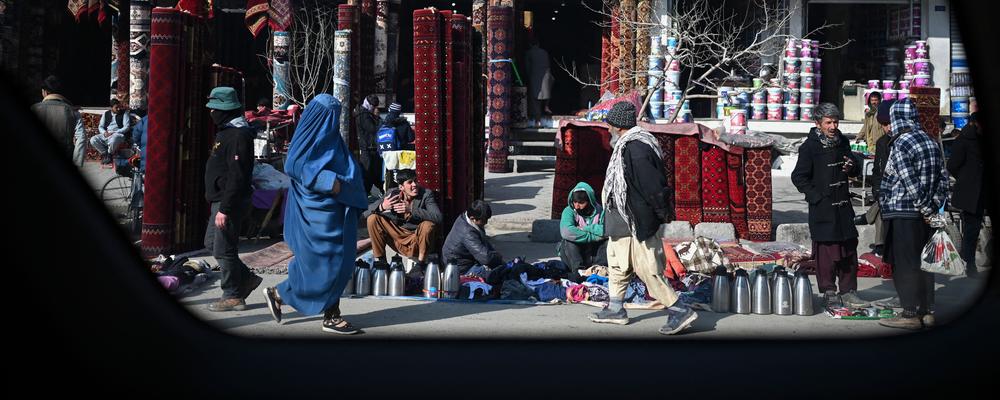 People walk along a market area in Kabul on January 29, 2022. (Photo by Mohd RASFAN / AFP) (Photo by MOHD RASFAN/AFP via Getty Images)