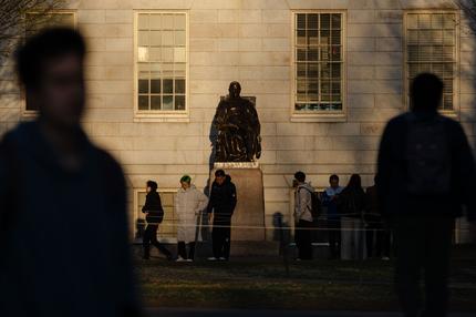 USA: CAMBRIDGE, MASSACHUSETTS - APRIL 17: People gather to take photos with the John Harvard Statue at Harvard University on April 17, 2025 in Cambridge, Massachusetts. The Trump istration announced that it would block Harvard University from receiving $2.2 billion in federal grants and $60 million in contracts after the school refused demands to adopt new policies relating to student and faculty conduct, issions, anti-semitism on campus and DEI. (Photo by Sophie Park/Getty Images)