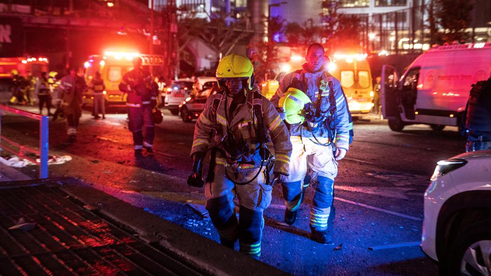  Firefighters work at an impact site following missile attack from Iran on Israel, in Tel Aviv, June 14, 2025.