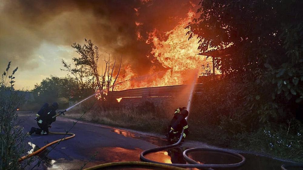  Feuerwehrleute löschen ein Feuer nach dem nächtlichen russischen Angriff in der Region Kyjiw.