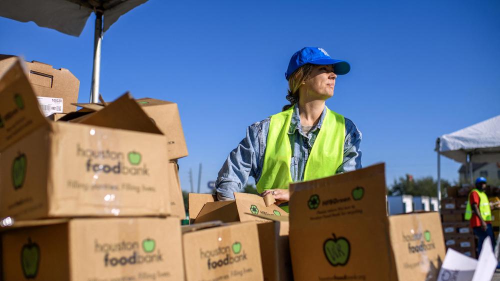  US-POLITICS-ECONOMY-SHUTDOWN
Volunteer Nikki Wagner fills boxes with free goods during a special food distribution by the Houston Food Bank Program at the NRG Stadium in Houston, Texas, on November 1, 2025. Approximately one in eight Americans receive food stamp benefits from the US government, a program at risk of not being funded as of Saturday by the federal Supplemental Nutrition Assistance Program (SNAP) due to the government shutdown. (Photo by Mark Felix / AFP) (Photo by MARK FELIX/AFP via Getty Images)