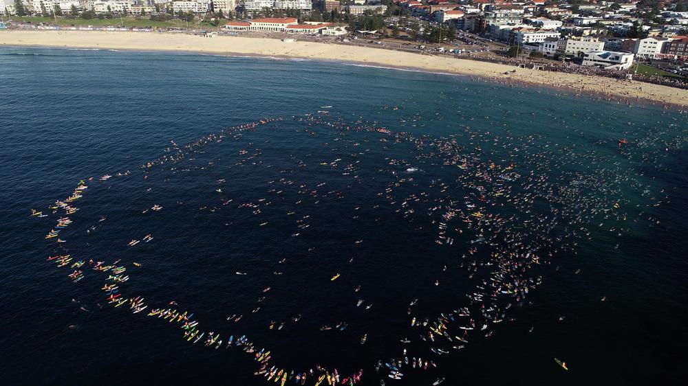  Surfer haben im Meer am Bondi Beach einen Kreis gebildet und an die Toten erinnert.