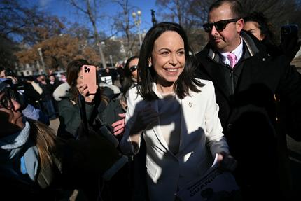 Venezuela: Venezuelan opposition leader Maria Corina Machado greets supporters outside the White House following a meeting with US President Donald Trump in Washington, DC, on January 15, 2026. (Photo by Brendan SMIALOWSKI / AFP via Getty Images)
