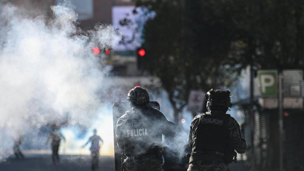  Polizisten setzen Tränengas gegen Demontranten ein.