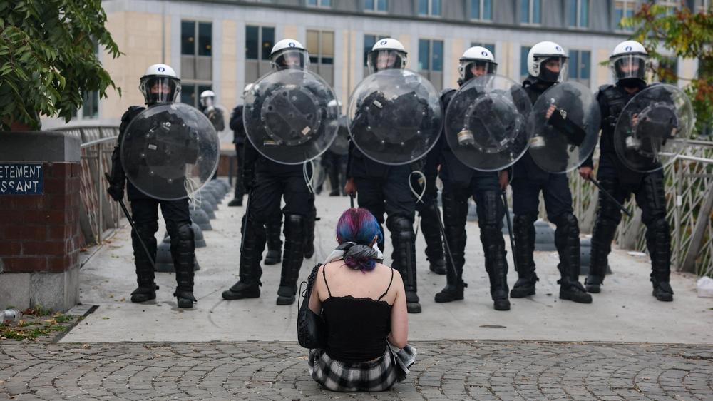 Schulproteste in Belgien: Eine Schülerin protestiert vor Einsatzkräften der Polizei in Lüttich.