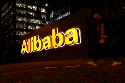 Pandora Papers: FILE PHOTO: A man walks past a logo of Alibaba Group at its office building in Beijing, China August 9, 2021. REUTERS/Tingshu Wang/File Photo