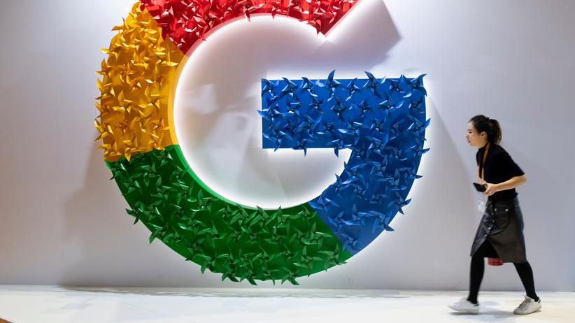 Google: Eine Frau geht an einem Google-Logo vorbei.